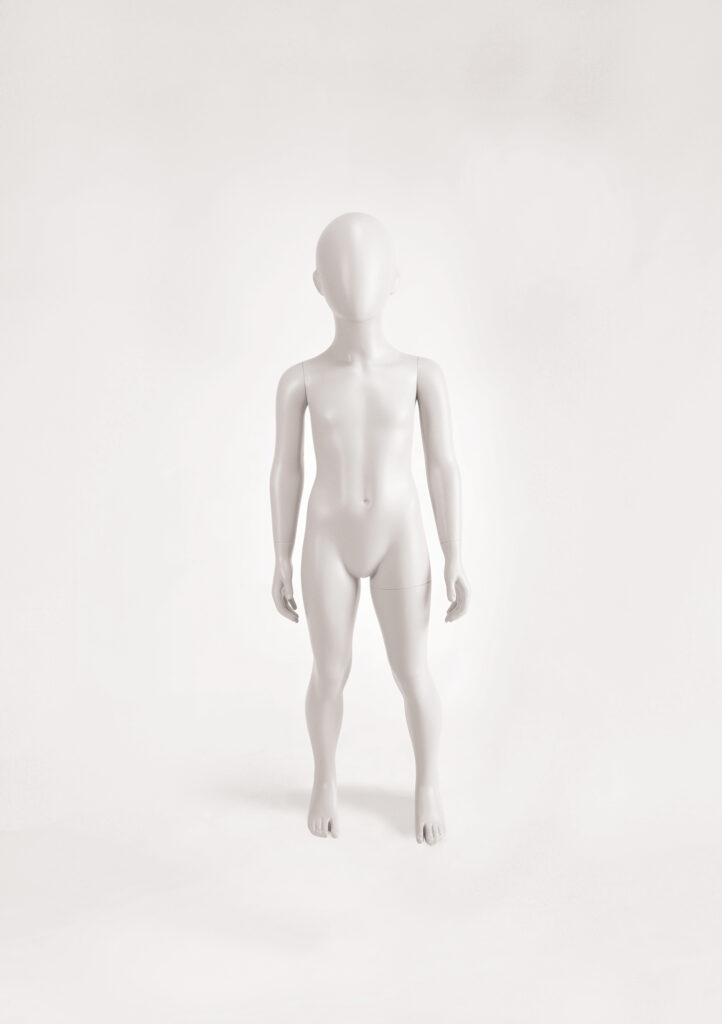 Mannequin by HOL A featureless, white FK02 mannequin of a child stands upright with arms slightly away from its sides against a soft, light-colored background. The Farringdon Kids mannequin is bald, with no facial features or clothing.