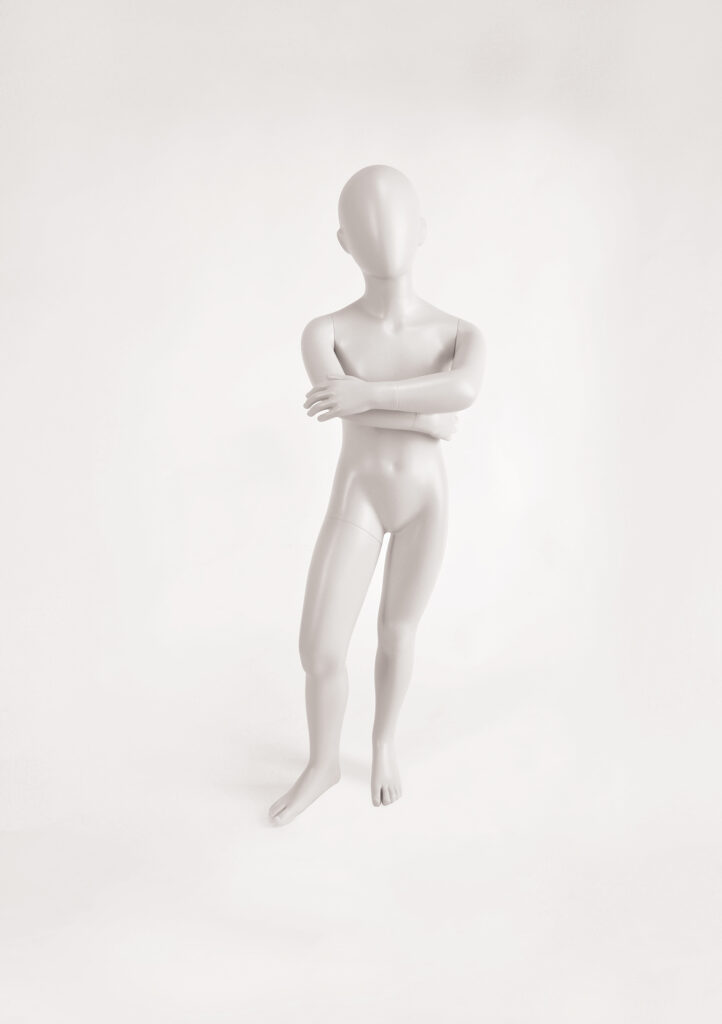 Mannequin by HOL A featureless, white mannequin stands against a white background. The mannequin, labeled FK07 by Farringdon Kids, has no distinct facial features and its arms are crossed over its chest. It is positioned slightly leaning to one side with one leg bent.