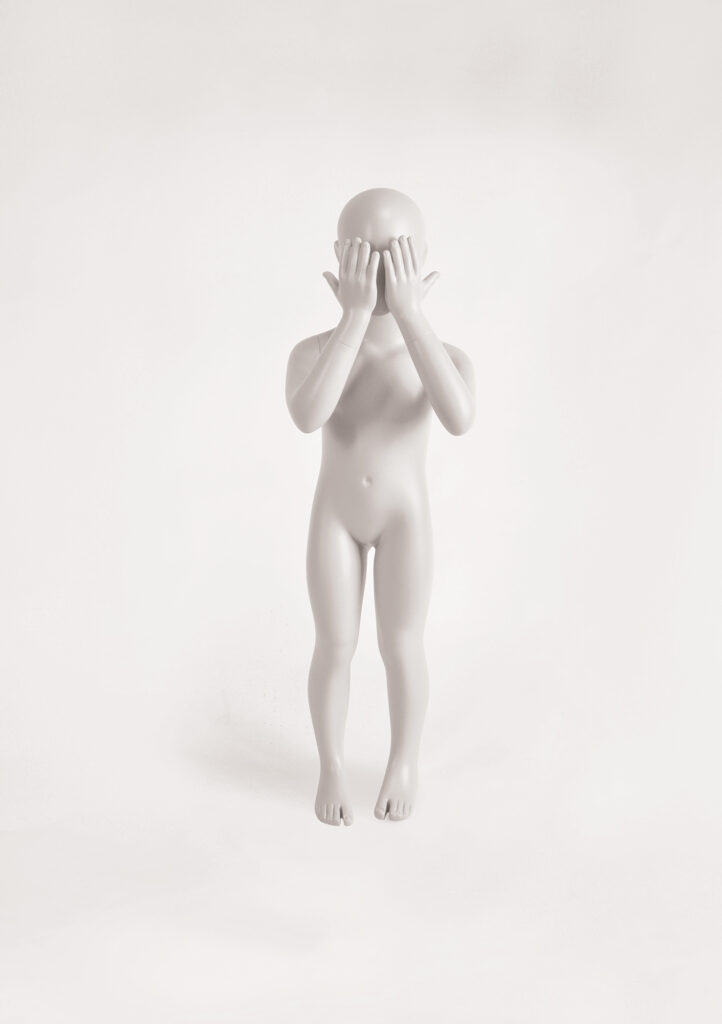 Mannequin by HOL A grayscale sculpture of a naked, featureless human figure stands upright with its hands covering its face. The FK08 figure's smooth and minimalist design contrasts with the white background, giving it a stark and abstract appearance.